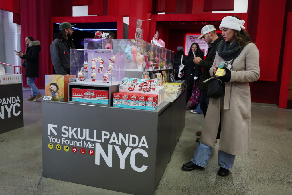 Consumers shop for Labubus and other art toys at Pop Mart's Skullpanda pop-up shop in Manhattan, in New York City