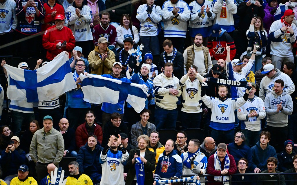 Finland ice hockey fans celebrating during a game against Sweden.