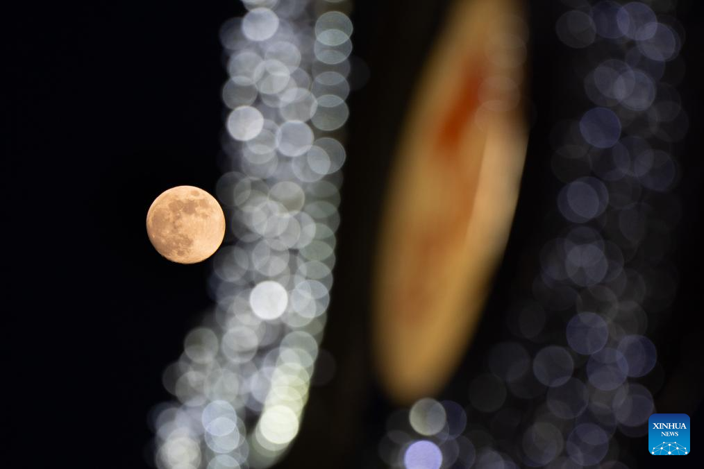 Bright moon hangs over Warsaw, Poland -Xinhua