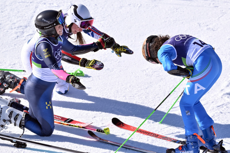 Norway's Thea Louise Stjernesund and Sweden's Sara Hector bow in front of Italy's Federica Brignone after she wins the women's giant slalom in Cortina d'Ampezzo on Feb. 15, 2026. 