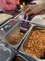 FILE - Health officials measure the temperature of beans at an unpermitted food stand in Everett.