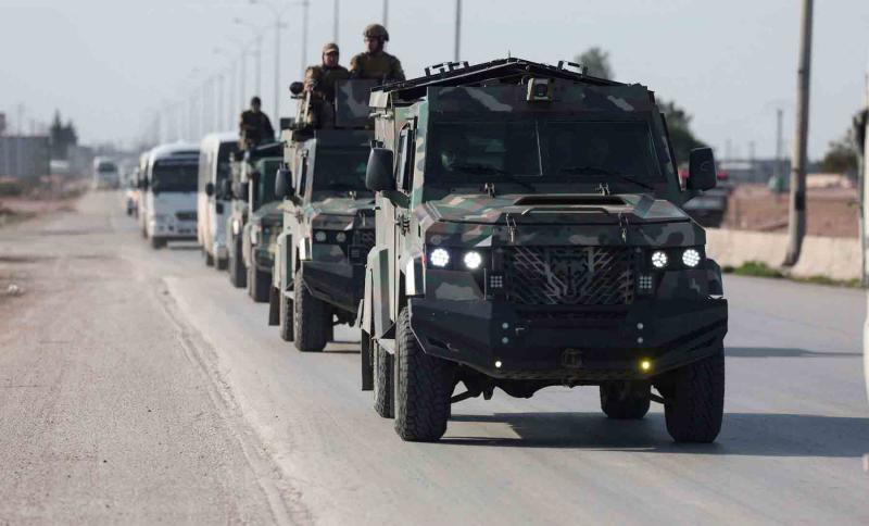 Soldiers in military vehicles on a road in Aleppo, Syria, January 14, 2026.