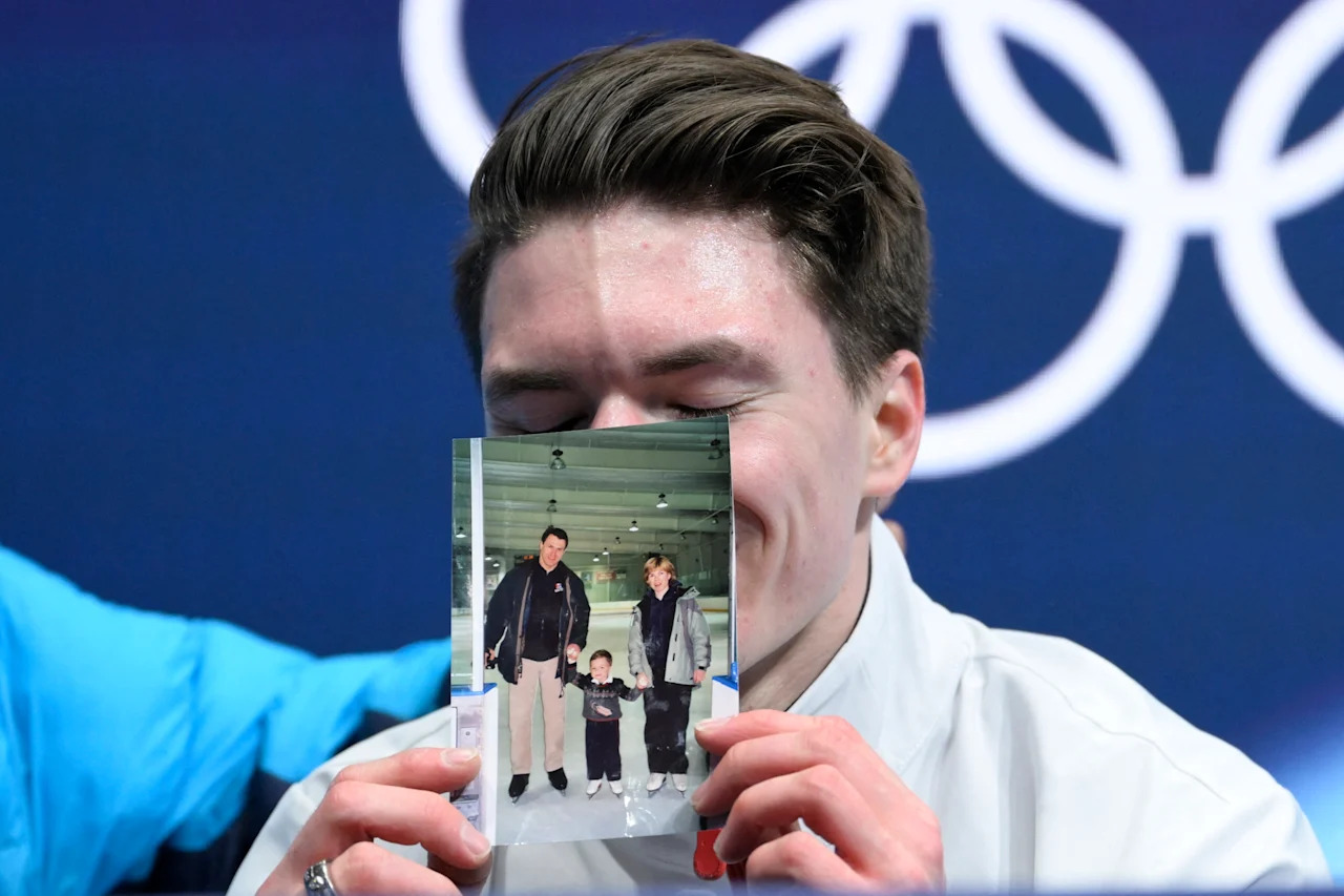 USA's Maxim Naumov reacts in the kiss and cry area after competing in the figure skating men's singles free skating final during the Milano Cortina 2026 Winter Olympic Games at Milano Ice Skating Arena in Milan on February 13, 2026. Naumov's parents Vadim Naumov and Evgenia Shishkova died after a mid-air collision of an American Airlines plane and an US Army helicopter in Washington DC on January 29, 2025. (Photo by WANG Zhao / AFP via Getty Images)