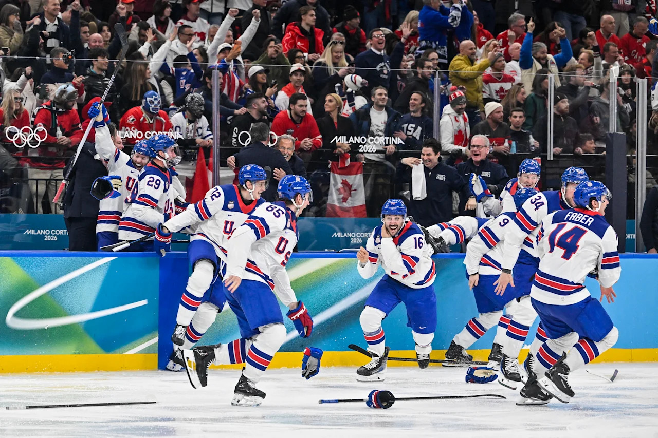 USA players celebrate winning the men's gold medal ice hockey match between Canada and USA at the Milano Santagiulia Ice Hockey Arena during the Milano Cortina 2026 Winter Olympic Games in Milan, on February 22, 2026. (Photo by Alexander NEMENOV / AFP via Getty Images)