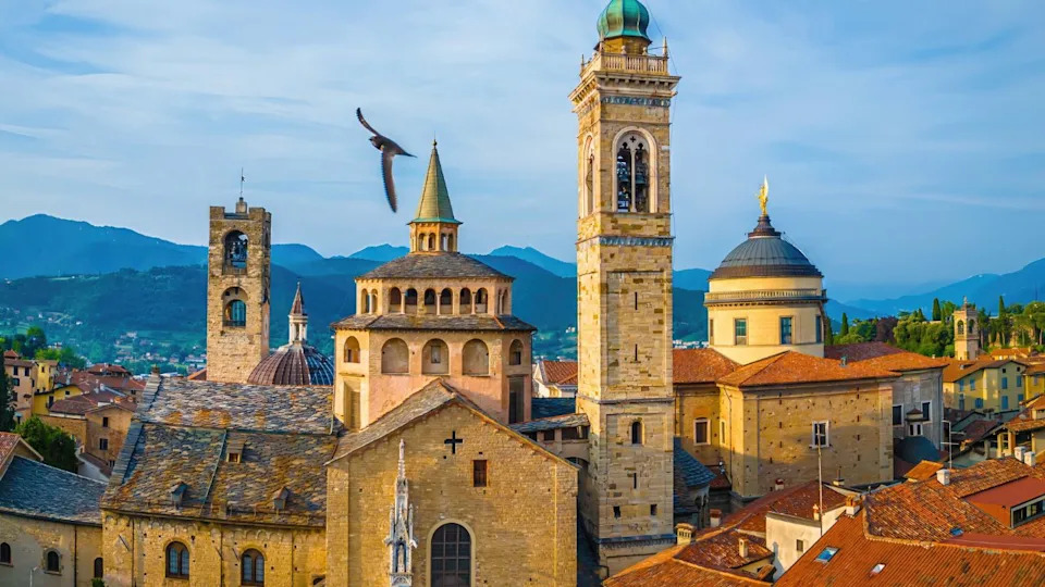Aerial cityscape of Bergamo’s old town, Italy. Features terracotta roofs, medieval towers, and churches. Perfect for travel, tourism, architecture, and real estate promotions