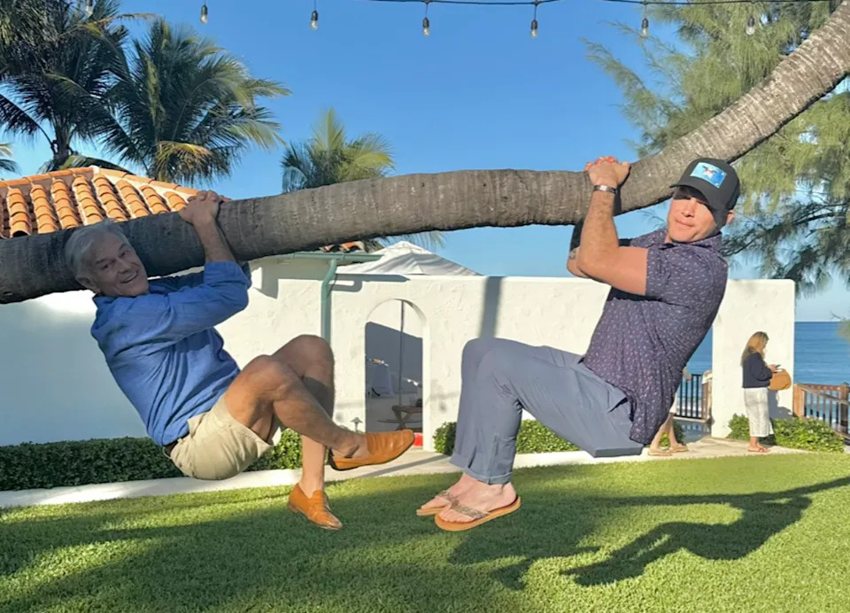 Defense Secretary Pete Hegseth pictured this week doing pull-ups on a palm tree in Palm Beach, Florida, with Dr. Mehmet Oz who heads up the Centers for Medicare and Medicaid (Dr Mehmet Oz)