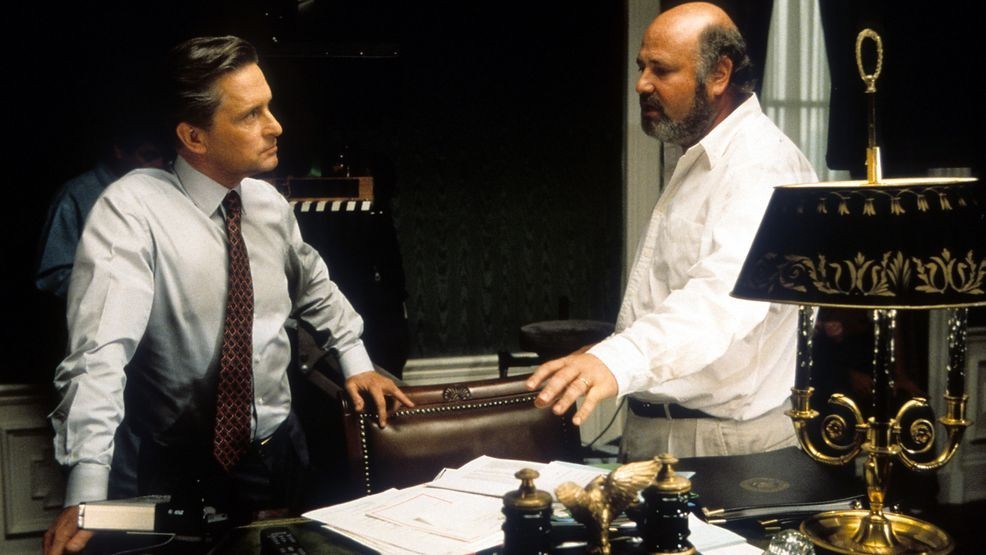 Michael Douglas listening to Director Rob Reiner in between scenes from the film 'The American President', 1995. (Photo by Universal/Getty Images)