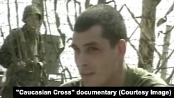 An image of Roman Demurchiev, taken from a documentary film, when he was serving as a younger soldier during the war in Chechnya.