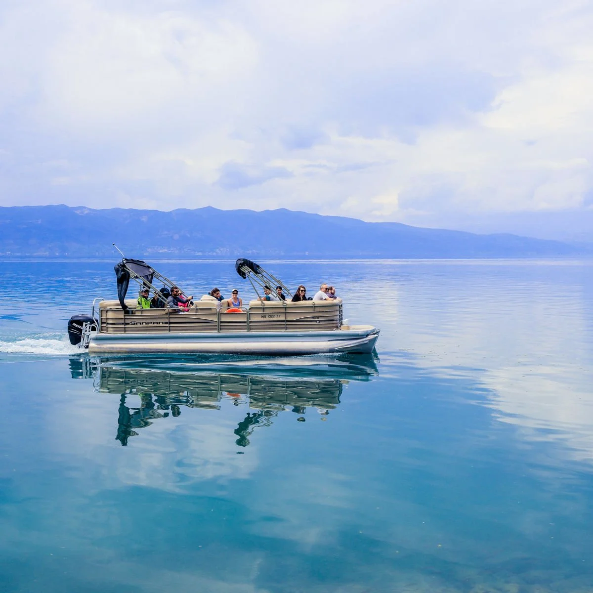 Boat ride on glassy waters of Lake Ohrid, North Macedonia