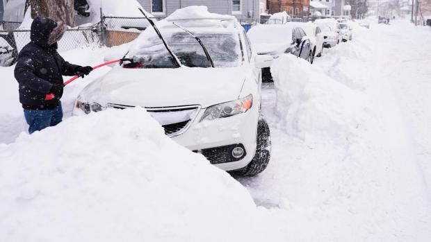 FILE - Rafael Tavares digs his car, which was encased about 20 inches of snow, during a winter storm Jan. 26, 2026, in Lawrence, Mass. (AP Photo/Charles Krupa, File)