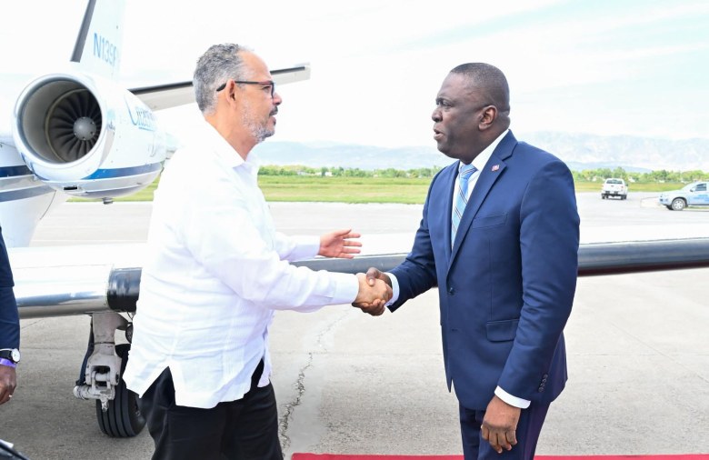 Haitian Prime Minister Alix Didier Fils-Aimé greets Justice Minister Patrick Pélissier, who led the transition government during his absence, on the tarmac at Toussaint Louverture International Airport in Port-au-Prince upon his return from the 50th CARICOM Heads of Government Conference in Saint Kitts and Nevis, Thursday, February 26, 2026. Photo via the Prime Minister’s Office.
