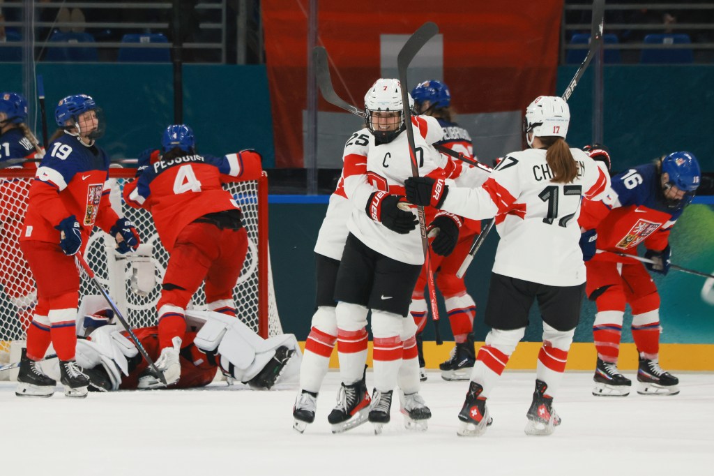  Lara Christen #17 (R) of Team Switzerland celebrates scoring a goal with teammates Alina Muller #25 and Lara Stalder #7 of Team Switzerland in the third period during the Women's Preliminary Round Group A match between Czechia and Switzerland on day zero of the Milano Cortina 2026 Winter Olympic games at Milano Santagiulia Ice Hockey Arena on February 06, 2026 in Milan, Italy. 