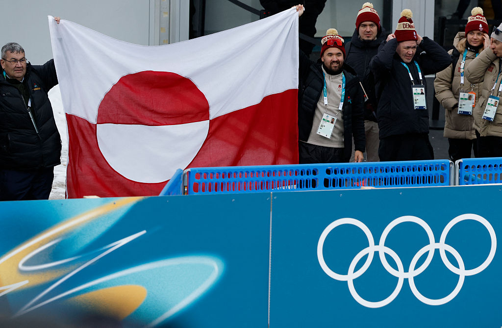 A Danish delegation with a Greenland flag during the women's biathlon 15km individual event during the Milano Cortina 2026 Winter Olympic Games on 11 February 2026 (Odd Andersen/AFP via Getty Images)