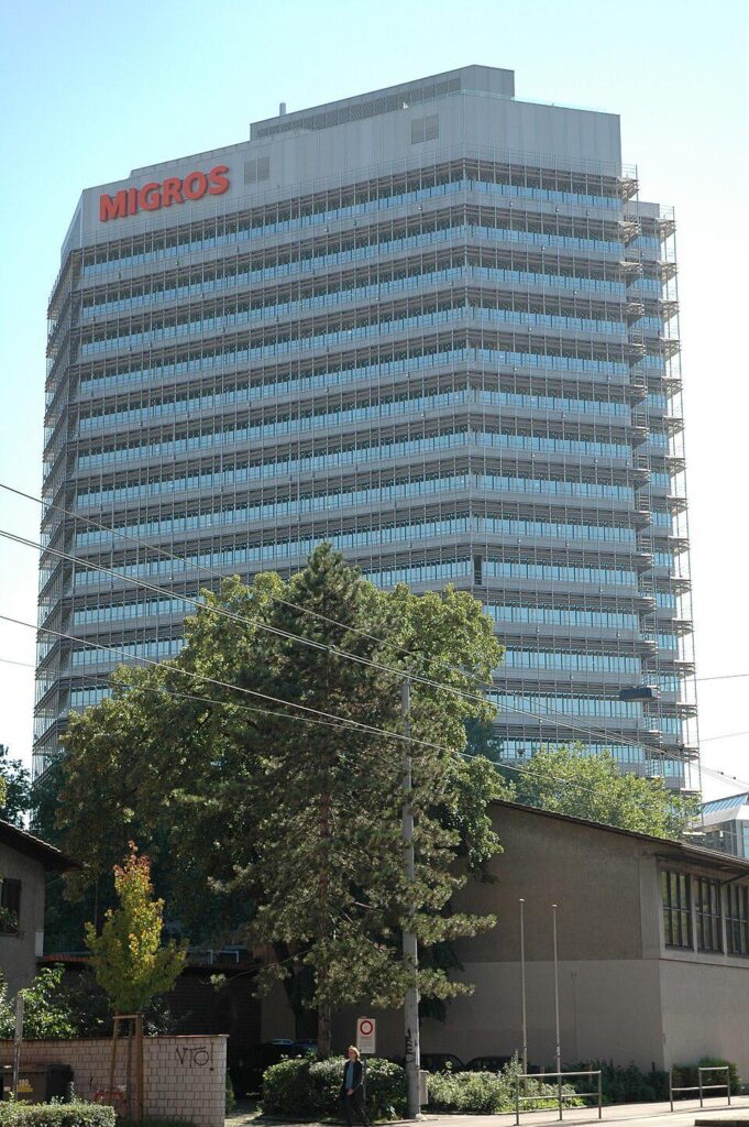 TIL that the Switzerlands largest supermarket Migros, doesn’t sell alcohol or tobacco in stores, pays no dividends, caps profits by lowering prices if earnings exceeds 5%, is a cooperative with 2M+ members, and donates 1% of revenue to social projects, purely out of the founders moral philosophy