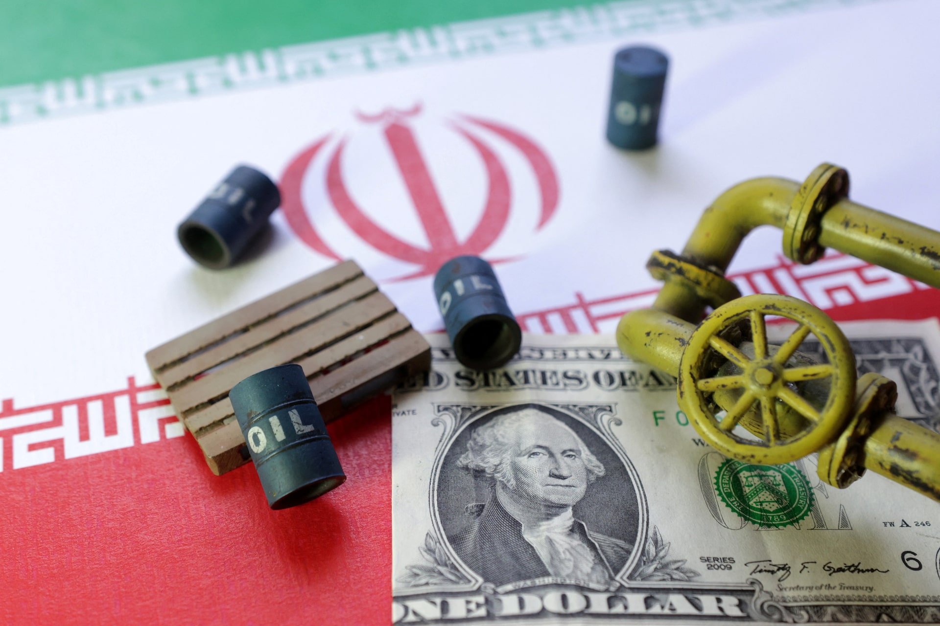 Illustration shows Iran flag, U.S dollar banknote and minatures of oil pump jack and barrels