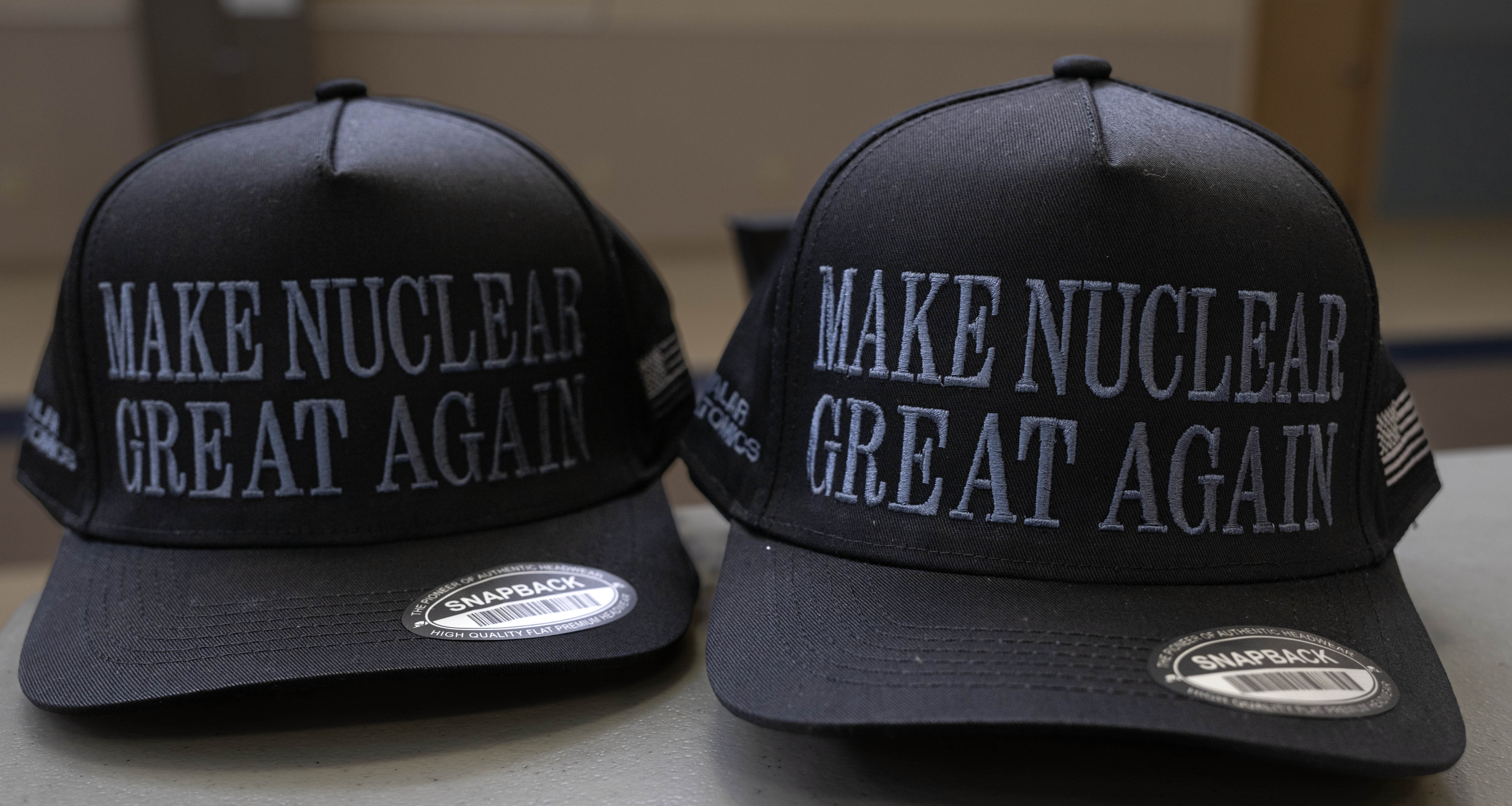 “Make Nuclear Great Again” hats are given out at March...