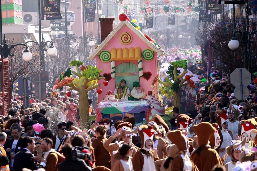 A lively scene from past Xanthi Carnival celebrations, featuring costumed performers, traditional masks, and enthusiastic crowds enjoying the festive atmosphere.