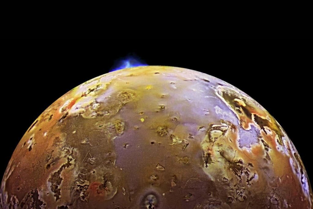 Synchronised volcanic eruptions on Io hint at a spongy interior