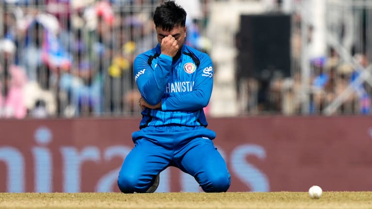 Afghanistan's captain Rashid Khan reacts after failing to catch a shot from New Zealand's Tim Seifert during the T20 World Cup cricket match.