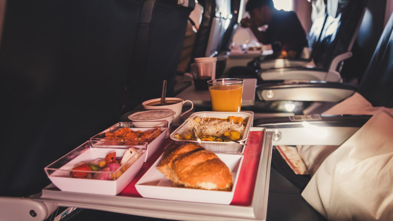 Spread of food and drink on a flight tray table