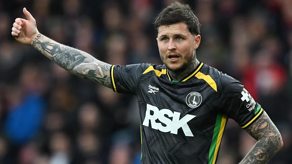 Lyndon Dykes shows a 'thumbs up' signal with his arm aloft