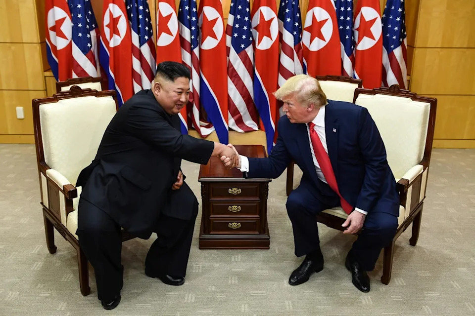 Kim Jong Un and Donald Trump shake hands during a meeting at the Military Demarcation Line that divides the Korean Peninsula on 30 June 2019 (AFP via Getty)
