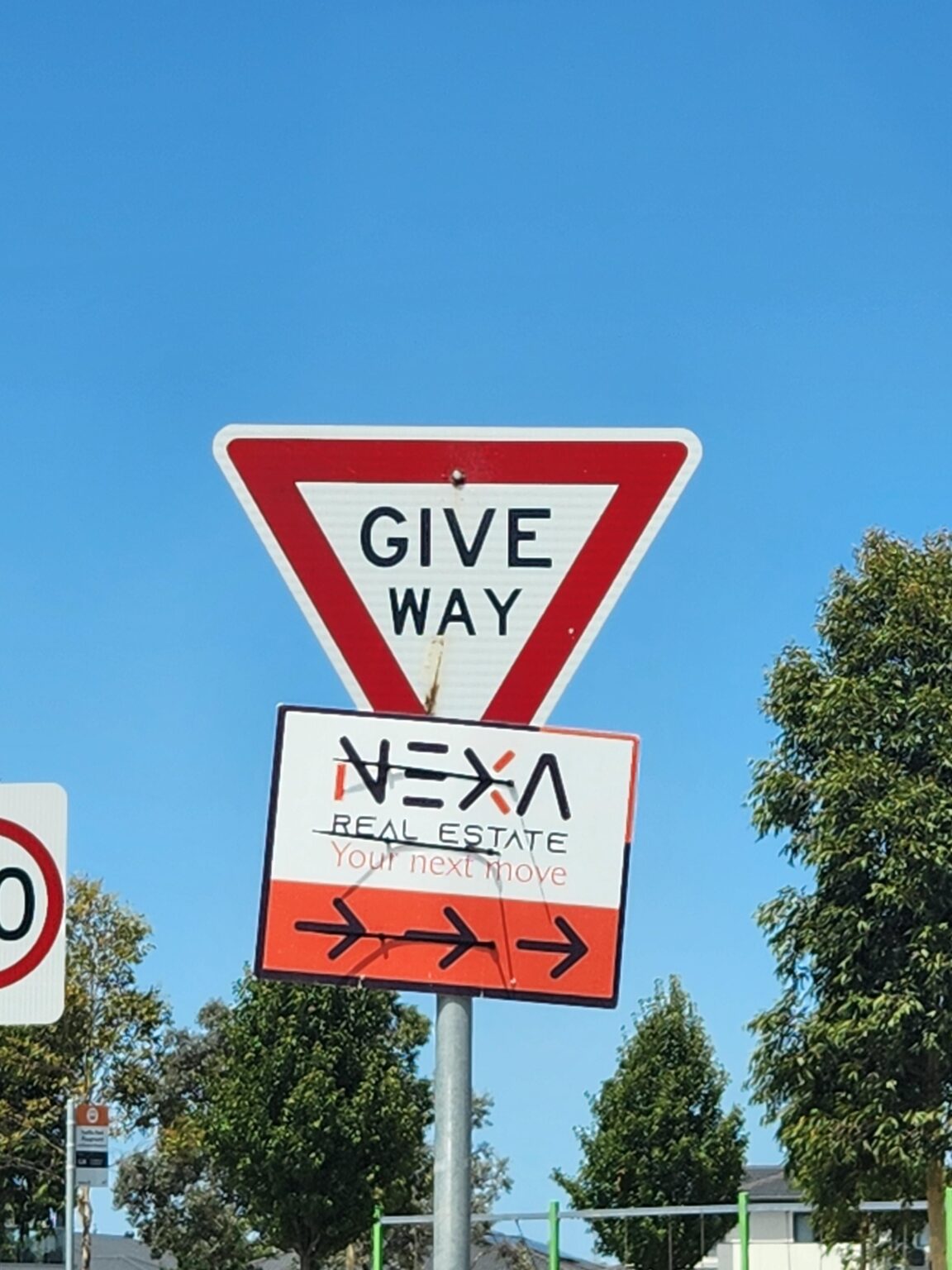 Not even road signs are free from real estate advertising. Nexa Real Estate, Kalkallo