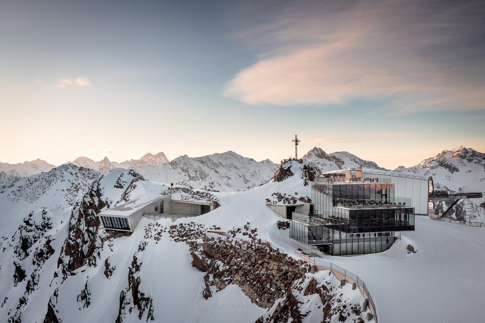 modern mountain facility surrounded by snowy peaks modern mountain facility surrounded by snowy peaks