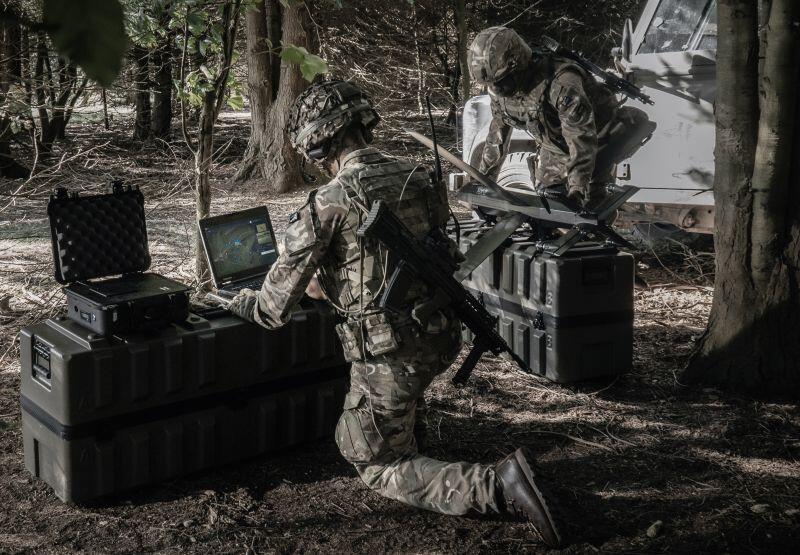 Soldiers in field with UAV
