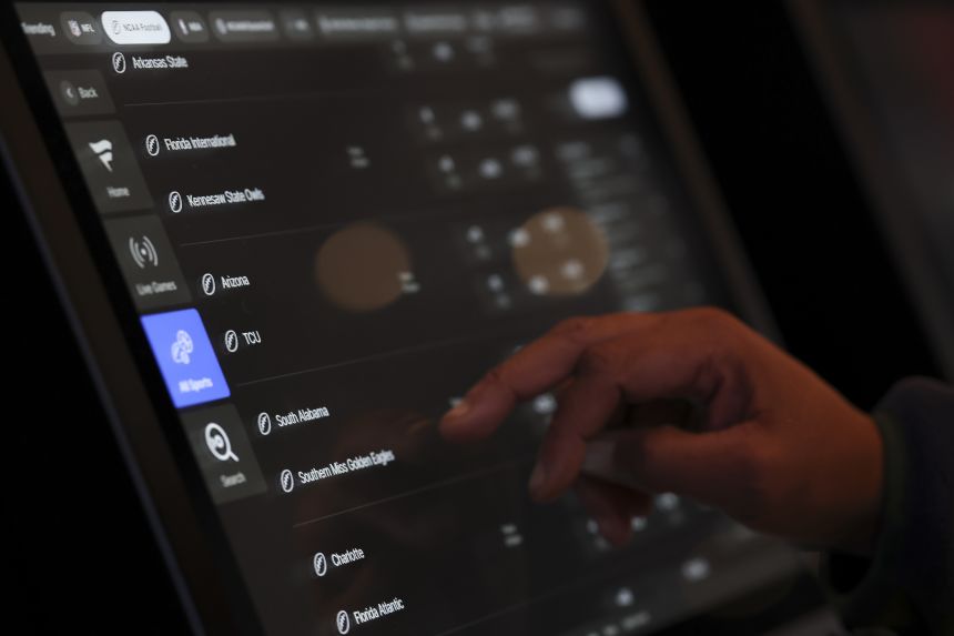 A person places a bet at a sportsbook in Columbus, Ohio, in 2024.