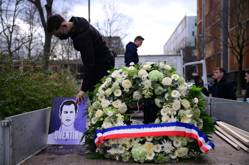 A participant leaves a tribute to far-right activist Quentin Deranque, who died after being attacked on the sidelines of a far-right protest in Lyon on February 21.