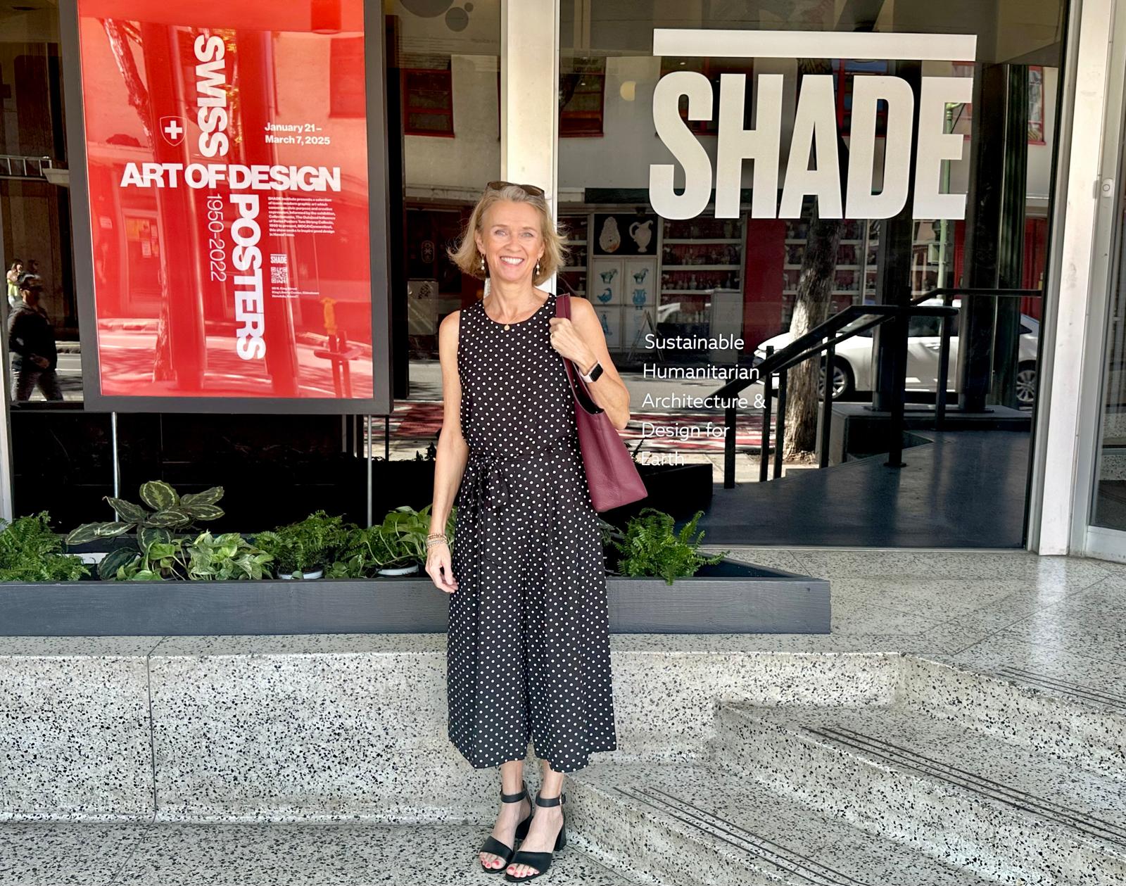 A woman in front of a poster entitled "Art of Design: Swiss Posters 1950–2022"