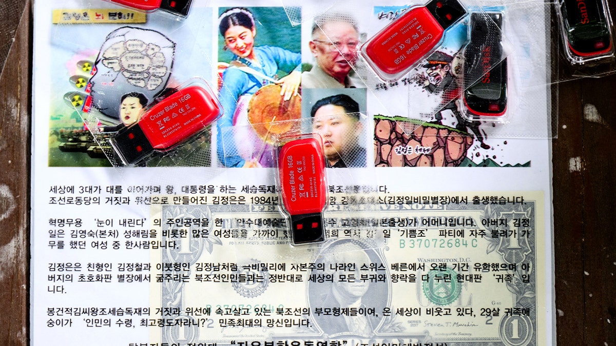 Leaflet bundle with U.S. currency and USB drives displayed during an interview in Seoul.