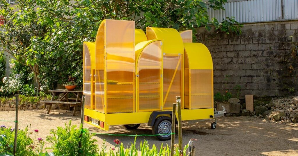modular yellow greenhouse travels on wheels through portugal