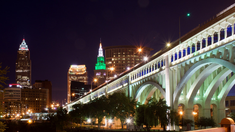 The skyline and illuminated bridge from The Flats in Cleveland, Ohio