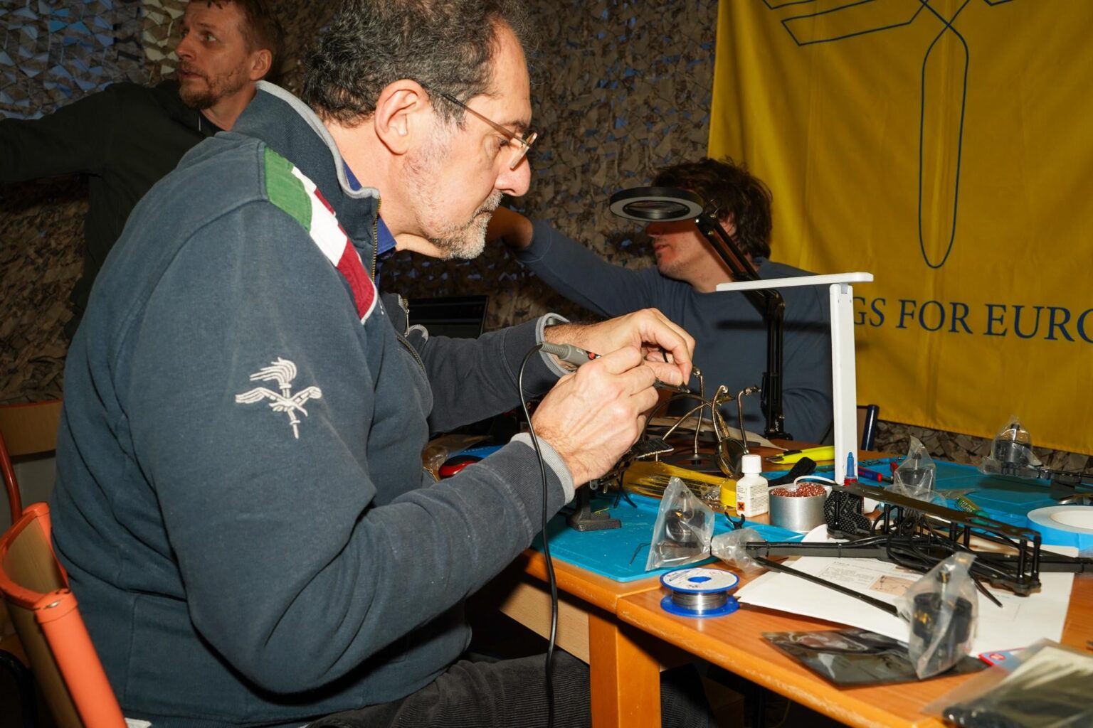 In a secret location in Brussels, ordinary people are aiding the war effort. They're assembling drones assisted by Wings for Europe
