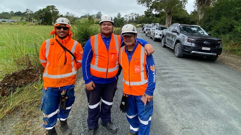 Pilot vehicle driver Tagiora Moka (centre) with traffic management colleagues James Hayward (left) and Roddy Shortland (right) and a queue of traffic waiting to head north into the weather-hit Whangaruru coast along Kaiikanui Rd on Monday, February 2. (Source: Susan Botting / LDR)