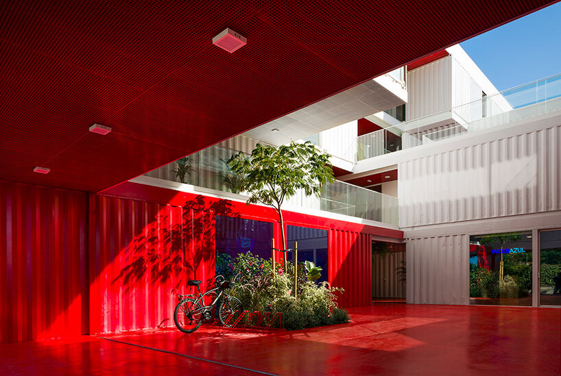 reused shipping containers form high-tech incubator by carquero arquitectura in spain
