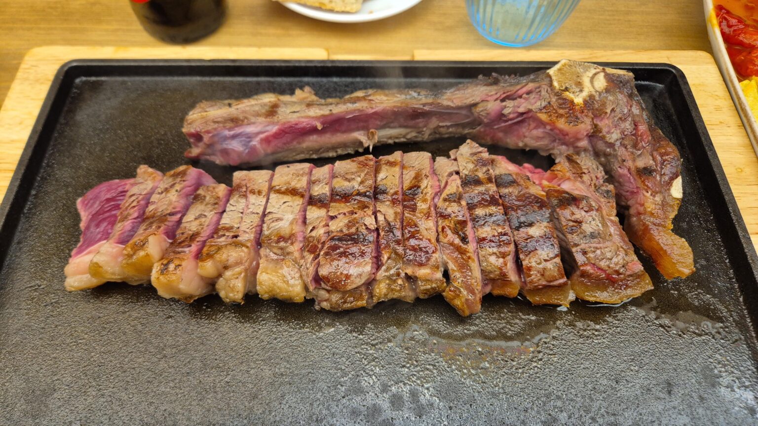 A chuleta, ask for it poco hecha, then finish it on a burning plate