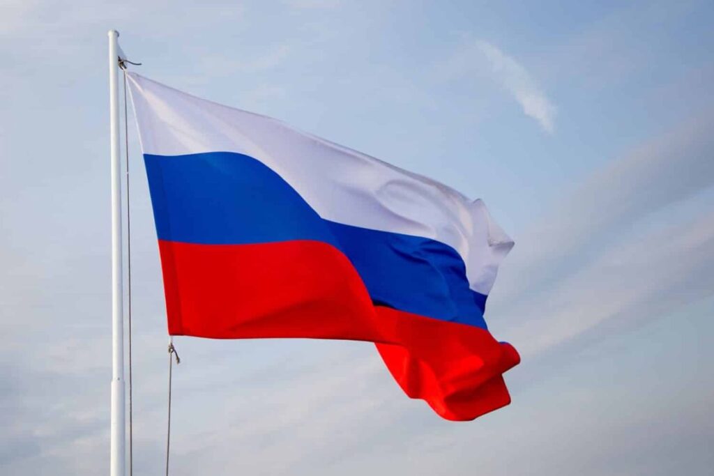 Russia's national flag flies proudly against a cloudy sky, symbolizing the nation amid escalating EU sanctions tensions. (Photo Credit: RJ)