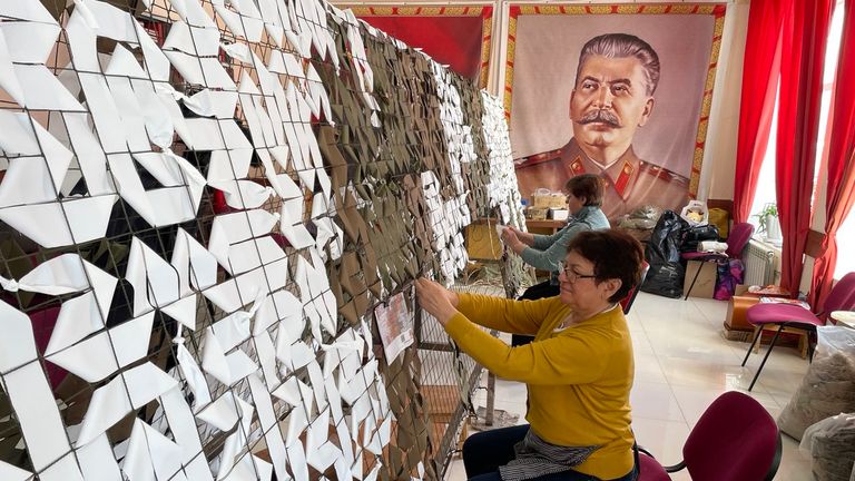Women weaving camouflage nets that will be sent to Russian soldiers at the front