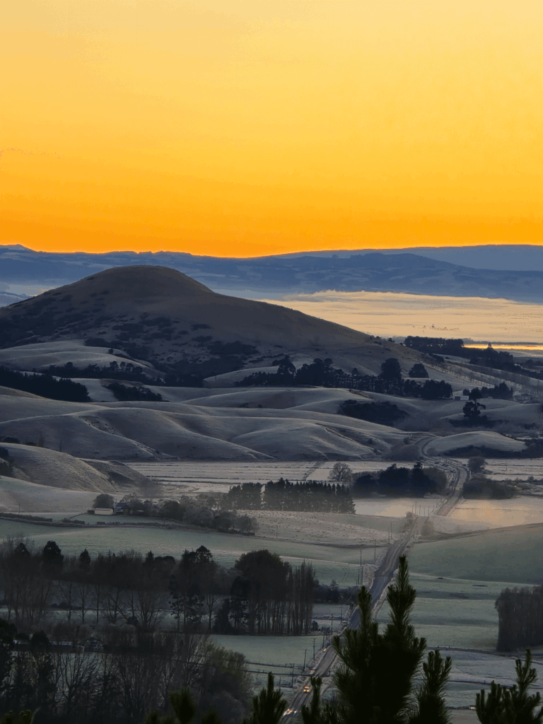 Golden morning light over Circle Hill. Milburn, Otago, New Zealand