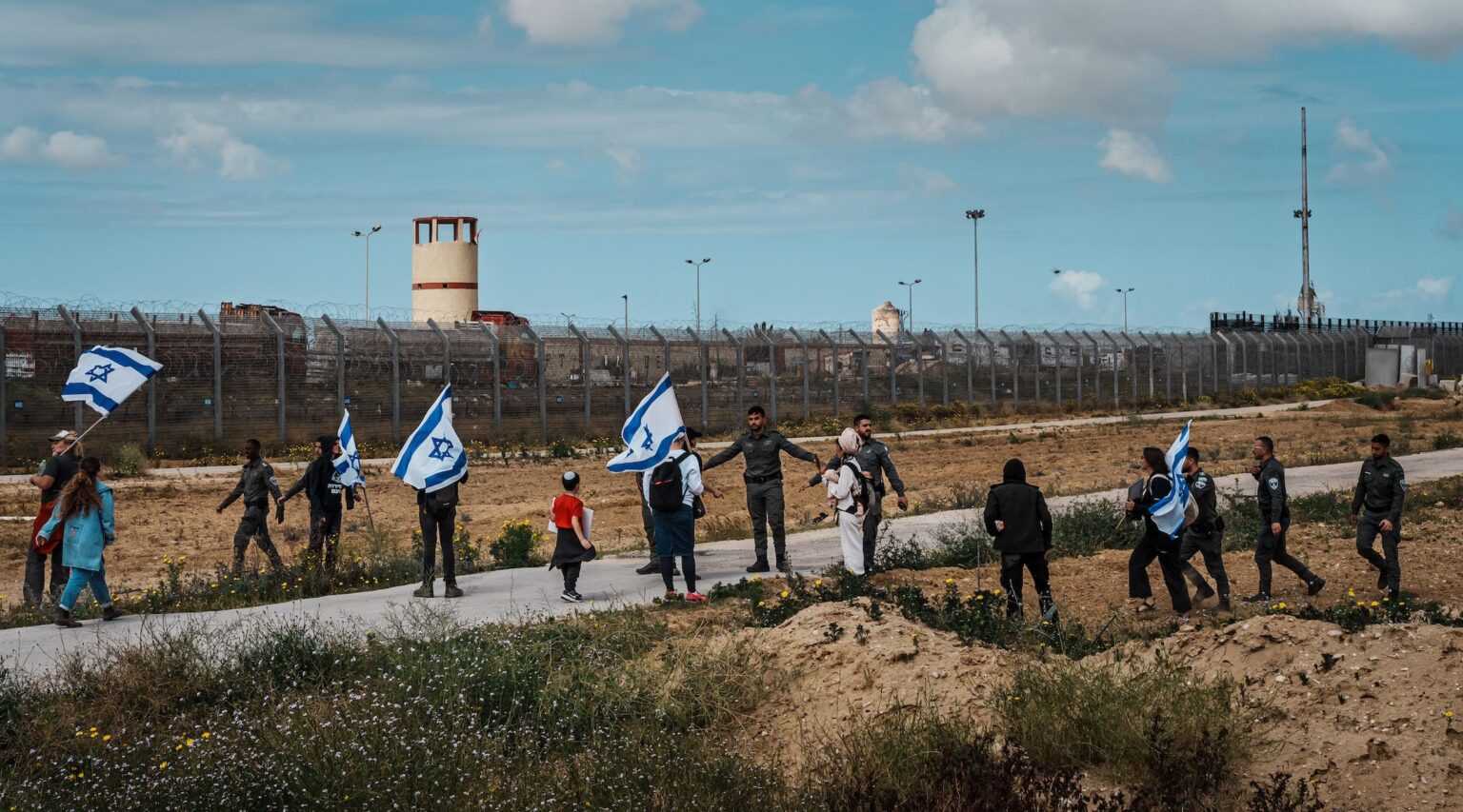 A photo of protesters with Israeli flags being blocked by soldiers.
