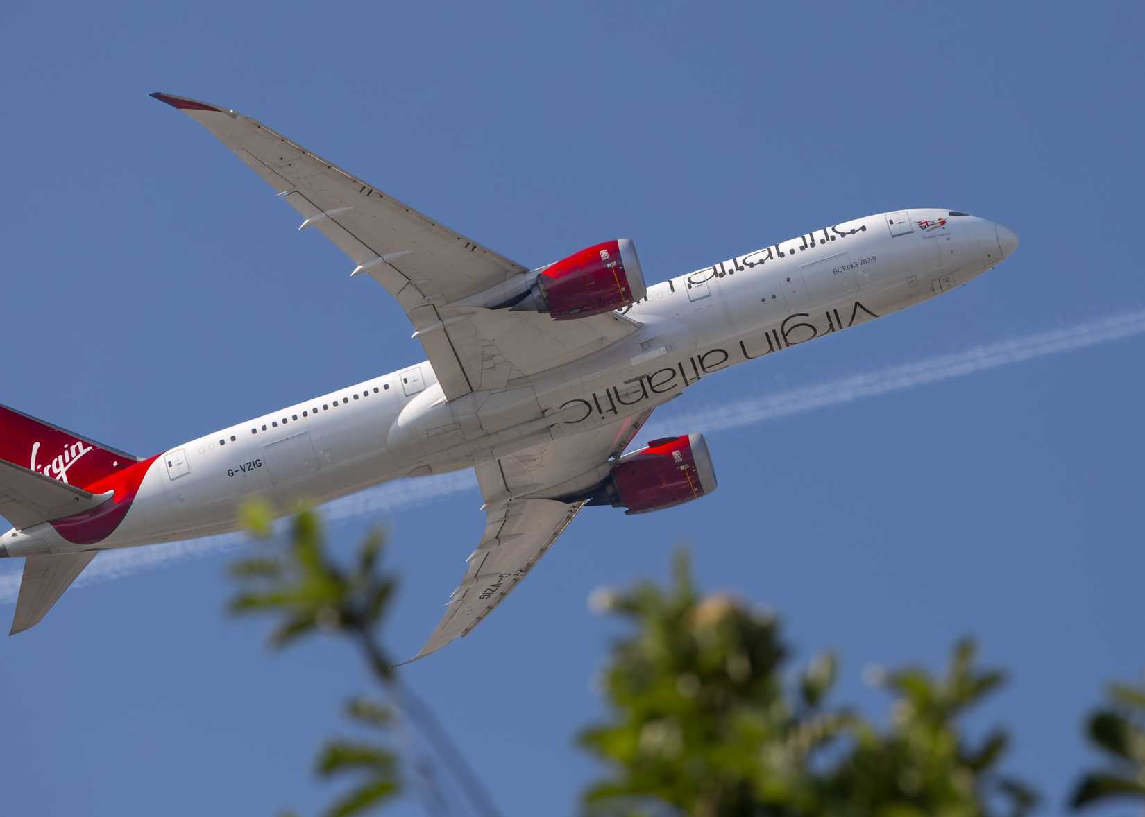 Virgin Atlantic, Boeing 787, Registration G-VZIG, flying overhead as captured below a tree