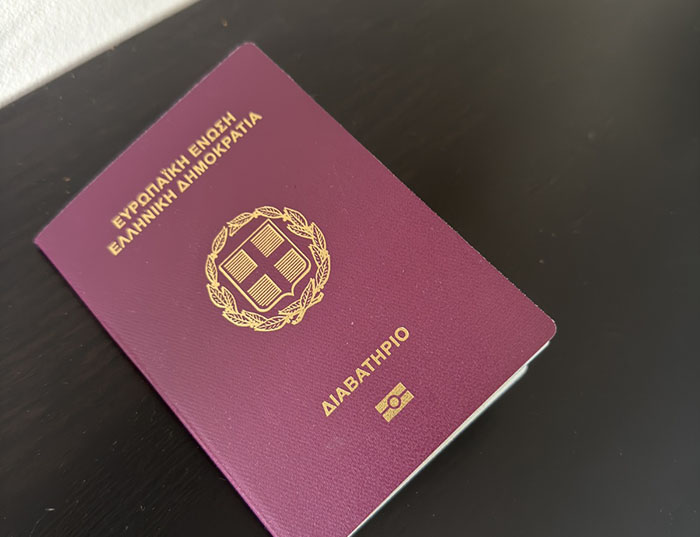 Greek passport and airplane interior signifying increased travel between North America and Greece