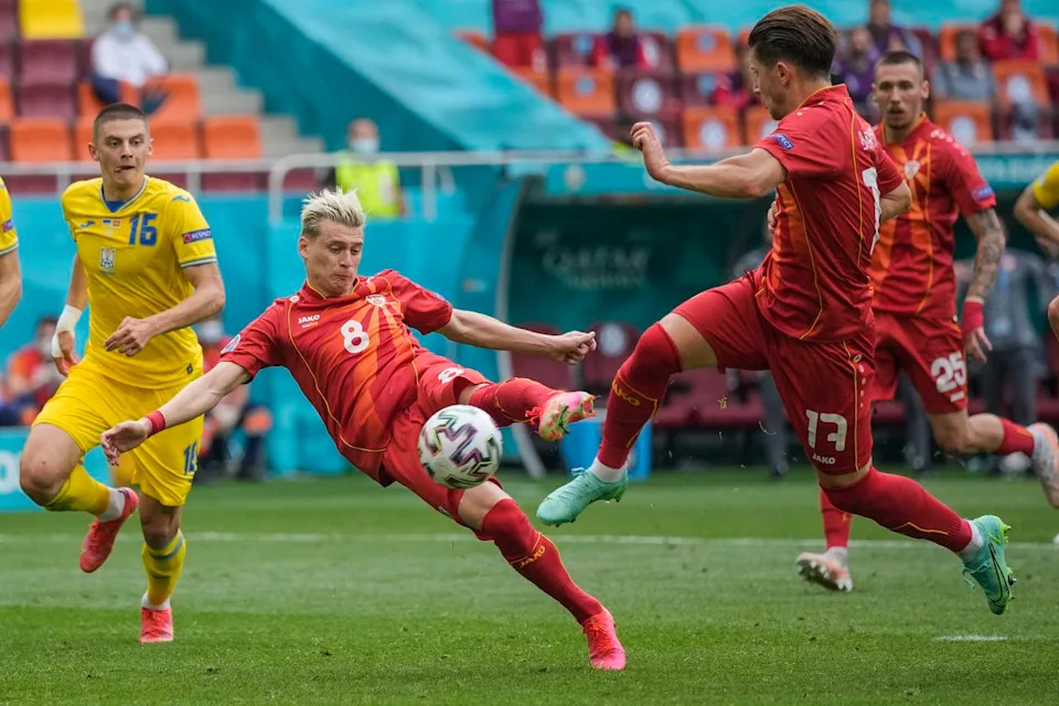  Ezgjan Alioski, centre, reacts to score the rebound after his penalty miss against Ukraine. 