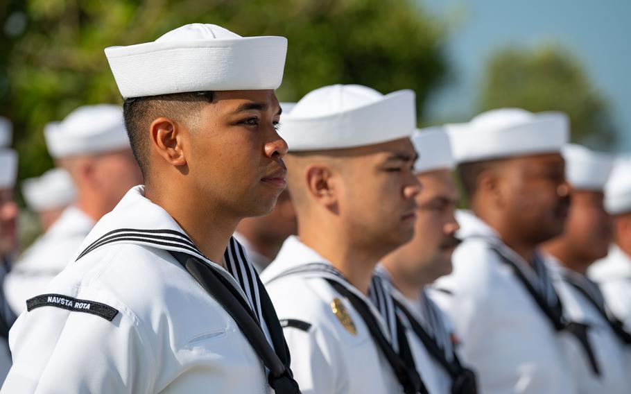 Sailors stand in formation.