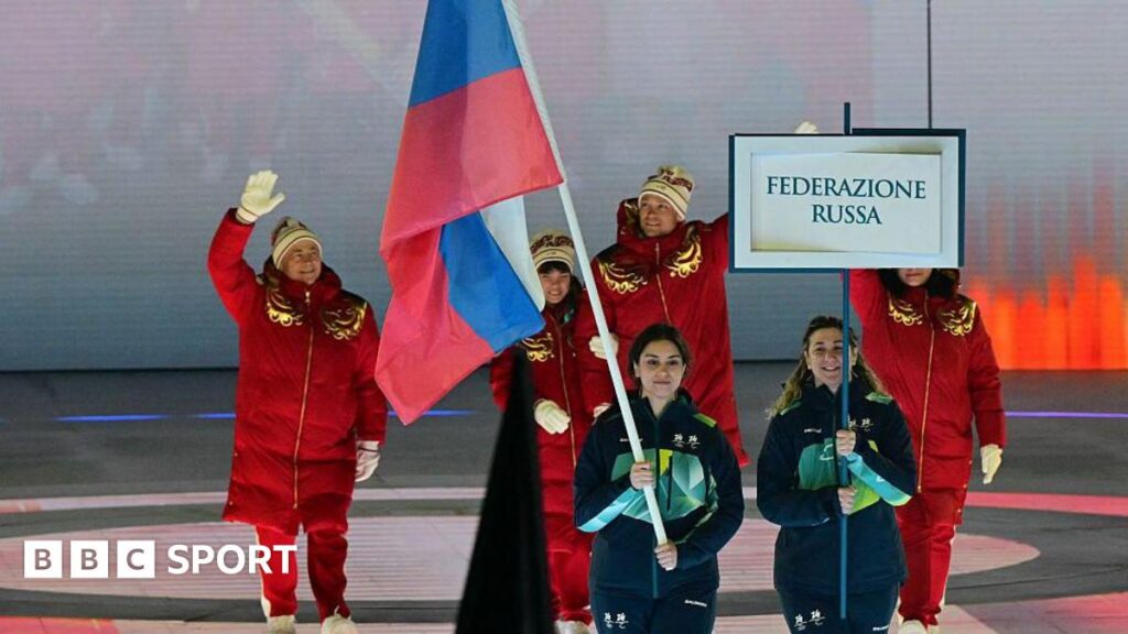 Winter Paralympics 2026: Russia and Belarus athletes parade behind national flags in opening ceremony Members of the Russia team walk behind the Russia flag into the opening ceremony
