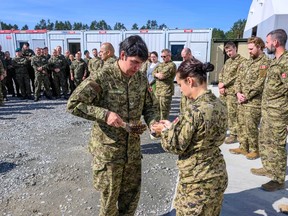 Cpl Nigel Nakogee of Attawapiskat is seen leading a smudging ceremony in Latvia