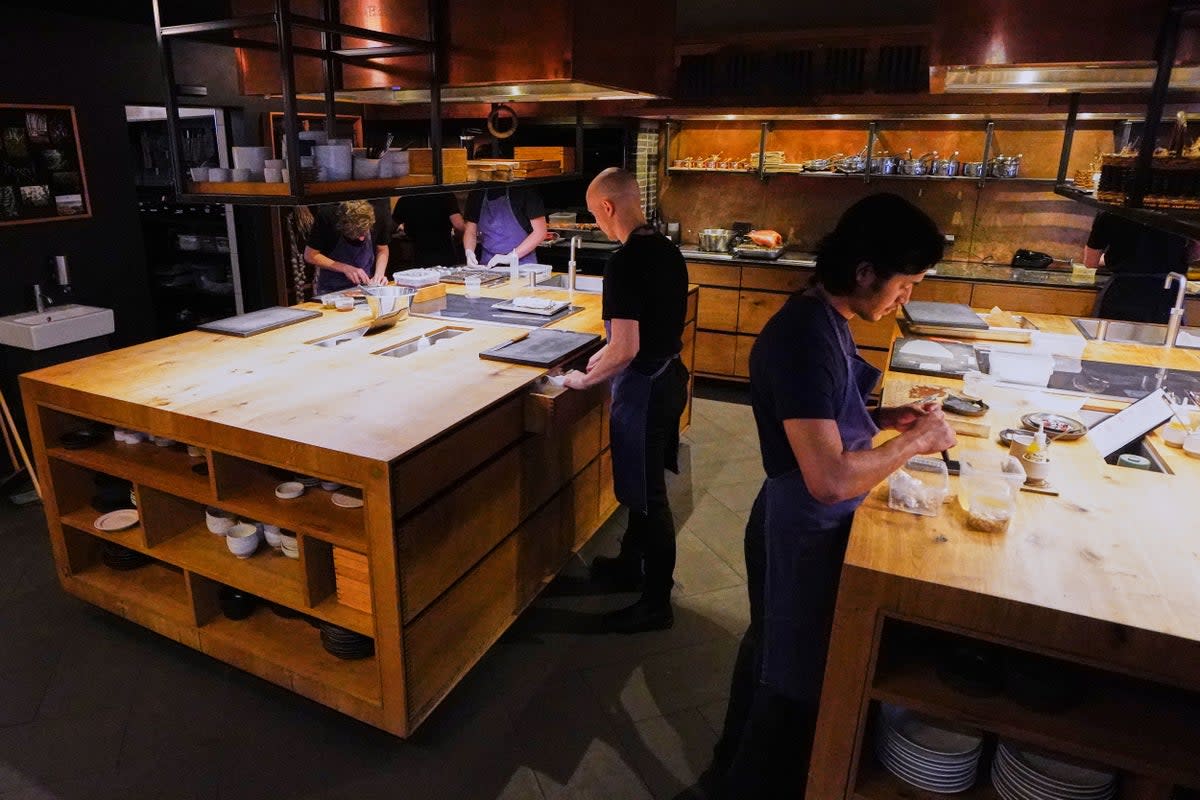 Chiefs prepare food at the restaurant Kadeau in Copenhagen, Denmark (AP)
